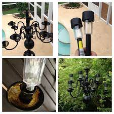 Old Chandelier Painted Black 97 Cent Solar Light From Walmart Hot Glued Where The Bulbs Were Outdoor Solar Lights Solar Light Bulb Outdoor Furniture Swing