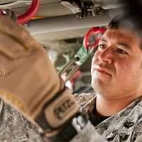 US Air Force (USAF) STAFF Sergeant (SSGT) Leroy Reherrera, a member of the  cable television installation team at Operating Location Alpha-Air Force  News (OLA-AF News), installs a connector onto coaxial cable used