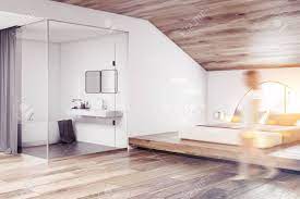 You will need a proper ventilation system, with a dual function. Woman Walking In Attic Bedroom With A Master Bed And Bathroom Stock Photo Picture And Royalty Free Image Image 108092135