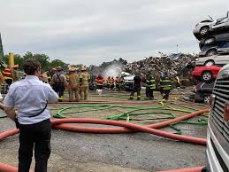 Firefighters prevent blaze from igniting mountain of junk cars in  Plainfield Township