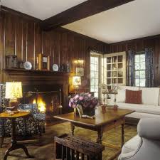 Traditional Living Room With Dark Wood Paneled Walls Glowing Lamps And Fireplace Cream Living Room Decor Traditional Traditional Living Room Wood Panel Walls