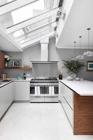 One of the most daunting tasks of any kitchen remodel is taking a stab at trying to redo your kitchen cabinets. Picture Of A Cute Neutral Kitchen Design With Windows On A Ceiling