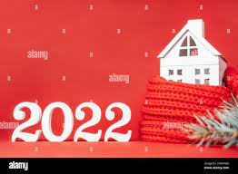 White House 2022 Red Christmas Trees Happy New Year 2022. White Wooden Numbers 2022 Stand With White Toy House  Wrapped In Red Scarf And Christmas Tree Branch On Red Background. Merry  Chri Stock Photo - Alamy