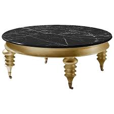 Rolling Gold Round Coffee Table With Black Marble Top And Gold Detailing From A Unique Round Gold Coffee Table Marble Round Coffee Table Round Coffee Table