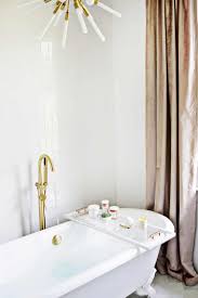 Compartments hold soap, sponges and supplies. Lucite Bathtub Caddy Diy A Beautiful Mess