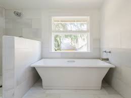 An elegant white marble bathroom with brass and gold touches is pure luxury with a modern feel a small contemporary bathroom with a white marble backsplash and white furniture plus a gallery wall a refined white bathroom with a white marble floor, black furniture, a crystal chandelier and statement mirrors 16 Gorgeous White Marble Bathrooms