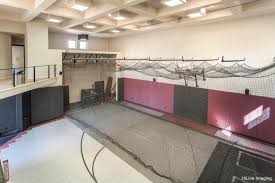 This Indoor Basketball Court Also Features A Retractable Batting Cage Restaurant Style Sideline Booths W Indoor Basketball Court Basketball Floor Garage Style