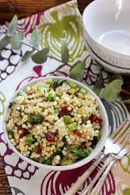 This couscous salad with its roasted squash and citrusy vinaigrette bridges the gap. Pearl Couscous With Greens Cranberries And Pine Nuts