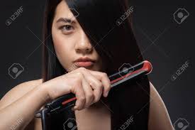 Style your hair with these professional asian hair straightening and create unique looks for any occasion. Portrait Of Young Asian Woman Straightening Hair With Hair Straightener Stock Photo Picture And Royalty Free Image Image 110038028