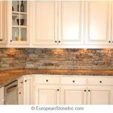 I used liquid nail, river rock, sanded grout and a sealer. Faux Rock Backsplash Kitchen Backsplash Designs Rustic Kitchen Backsplash Stone Backsplash Kitchen