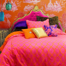 A red moroccan bedroom with plenty of pattern, boho rugs and bedding and carved wooden furniture. Moroccan Bedding Sets Spice Up Your Bedroom With Rich Colors
