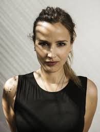 The us director appears in a black and white image, gazing up at some palm. Julia Ducournau Bio Wiki Net Worth Married Family Age