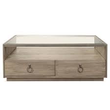 A very nice industrial looking coffee table with glass top and 2 storage areas. Riverside Furniture Sophie Glass Top Storage Coffee Table In Natural 50302