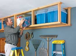 Wooden rack and tool holder exhibit the warm feeling. Overhead Garage Storage Ideas For Your Vertical Space