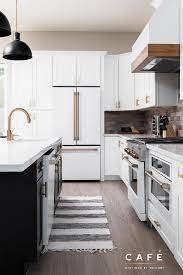 Matte White Cafe Appliances Paired With A Warm Brick Backsplash And Two Toned Cabinetry Win In This Ki Ge Cafe Appliances Home Decor Kitchen Lake House Kitchen