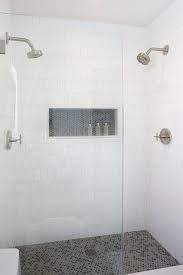 Spacious Walk In Shower Boasts Walls Clad In White Geometric Tiles Ann Sacks Hive Tiles Accented With A White Tile Shower Farmhouse Shower Tile Shower Niche