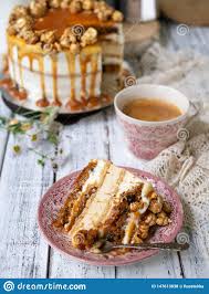 Carrot Cake with Salted Caramel and Cheesecake Inside, Decorated with  Popcorn and Caramel. a Slice of Cake with a Cup of Coffee, Stock Photo -  Image of baked, cooking: 147613838