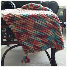 These pom pom patterns are a great way for young kids to learn one of the basic maths concepts. Pompom Cuddle Blanket Wool Baby Blanket Cuddle Blanket Knitted Blankets