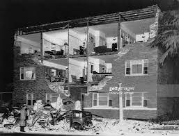 A Man Looks At What Remains Of A Car And An Apartment Building On Long Beach California California Photos Earthquake