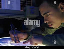 Petty Officer 3rd Class Lawrence Thomas, an engineer aboard the Coast Guard  Cutter Munro (WMSL 755) shows Fijian navy cadets the engine of the Munro's  35-foot Long Range Interceptor small boat off