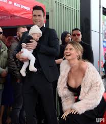 Maroon 5 frontman adam levine and his model wife behati prinsloo have splashed out close to £14 million on a home in the holmby hills estate in los angeles. Singer And Songwriter Adam Levine Is Joined By His Wife Model Behati Prinsloo And Their Daughter Dusty R Behati Prinsloo Style Adam And Behati Behati Prinsloo