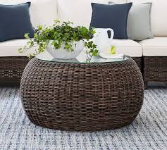 Hang string lights overhead to cast a cozy glow over the setup once the sun goes down. Torrey All Weather Wicker Outdoor Coffee Table Pouf Espresso Pottery Barn