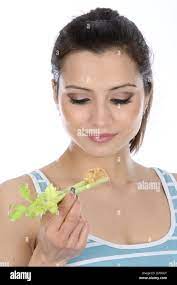 Model Released Woman Eating Celery And Peanut Butter Stock Photo Alamy