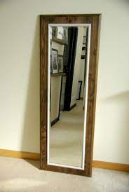 An old sink drain strap was cut into two small pieces to replace the plastic retainers. How To Build And Decorate With Rustic Mirror Frames