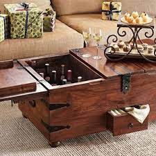 It doesn't get more convenient than a reclaimed wood coffee table with a hinged top that can easily be put to work for a laptop or family game nights. Wine Bar Treasure Trunk Chest Coffee Table Coffee Table Trunk Coffee Table Wood
