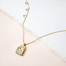 Featuring A Medley Of Wanderlust Co S Signature Charms The 14k Gold Plated Astra Locket Necklace Features A Gold Locket Necklace Gold Locket Locket Necklace