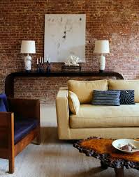 A contemporary living room with a grey brick wall and some leather and metal for an industrial touch. 57 Spectacular Interiors With Exposed Brick Walls