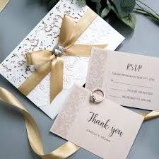 🥂【material】gold glitter laser cut invitation cards made of 250gsm glitter paper (200g , 230g is very thin, easily broken）, inner sheets is 250gsm ivroy pearl paper. Elegant Ivory Laser Cut Wedding Invitations With Gold Shimmer Ribbon And Diamante White And Blush Spring Wedding Colors Cheap Invitations Ws002 Wedding Invitations Wedding Invites Paper