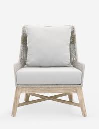 designed with a low profile back and a cheeky cutout this arm chair s tapered teak legs and removable cushi club chairs accent chairs indoor outdoor furniture