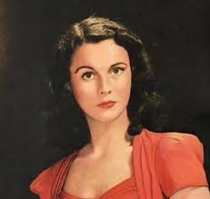 She is dainty as a flower, as slight as a willow, as exotic as a tiger  lily. Her chin is aggressive but pointed, making her small, vivid face,  heartshaped and deeply appealing.