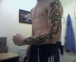 Nice tribal design tattoo on left full sleeve for men. Best Full Sleeve Tattoo Designs For Men