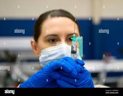 Sgt. 1st Class Sara Landon, Connecticut Army National Guard Medical  Detachment readiness noncommissioned officer, prepares vials of Pfizer  COVID-19 vaccine for use during a vaccination clinic at the Morton Hall Gym  at Naval Submarine Base New ...