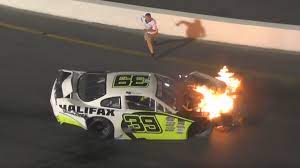 Mike jones was turning a corner at the south boston speedway in his nascar when he was tapped by a driver next to him and punted into a wall. Watch As Father Saves Son From Burning Race Car