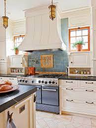 The colors of the tile complement the wood walls and the patterned table. Kitchen Backsplash Inspirations French Country Cottage