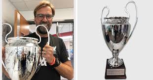 The world cup replica trophy sculptured from resin with pewter and gold accents. Liverpool Bid Cl Trophy Replica Signed By All Players For Charity Auction Tribuna Com
