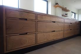 However, our natural wood drying process, which gives the planks all the time they need to mature, also speaks for the innovative strength of our traditional company. Heart Oak Finger Jointed Handleless Kitchen With Sapele Black Stained Veneer Handleless Kitchen Plywood Kitchen Modern Kitchen Interiors