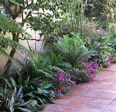 This Lush Colorful Planting Goes Beautifully With The Tiles And Coloration Of A Spanish Style Lan Spanish Landscaping Landscape Design Garden Landscape Design