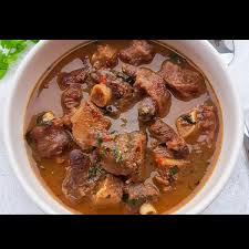 White rice is a popular staple that goes with everything: Goat Meat Pepper Soup With White Rice Made In Calabar