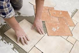 Floor Tiles Installation A Construction Worker Putting On New Floor Tiles Affiliate Installation Til Installing Tile Floor Tile Installation Tile Floor
