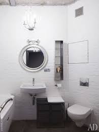 The Bathroom Is Done With Faux Brick Walls Some White Appliances And A Glass Shelf On The Wall Brick Bathroom Glass Shelves In Bathroom Faux Brick Walls