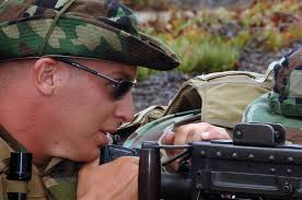 Master-at-Arms 2nd Class Bradley Wolfe assigned to Mobile Security Squadron  Three (MSS-3), Detachment 33, mans a .50-caliber machine gun.