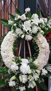 A Circular Arrangement Symbolizes Eternity White And Green Are Often Appropriate For Asian And Mormon Trad Flamingo Flower Wholesale Flowers Sympathy Flowers