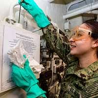 Damage Controlman 2nd Class Terrance Hendricks inventories gas masks in a  damage control locker aboard the Nimitz-class aircraft carrier USS Harry S.  Truman (CVN 75).