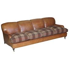 Neutral décor, earthy tones, and greys are complementary to light and dark brown couches. Large Tan Brown Leather Four Seat Sofa Tartan Wool Feather Cushions Howard Arm For Sale At 1stdibs