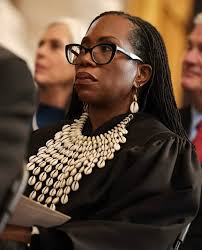 Regal. The Honorable Justice Ketanji Brown Jackson and her five were the  BEST part of the Presidential inauguration. During the ceremony, she wore  cowrie shells, a symbol of wealth, protection, and femininity