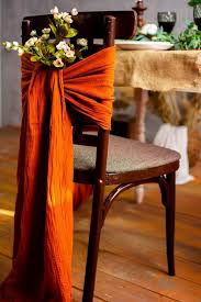 Double chocolate satin and burnt orange organza cravats on white chair covers. Burnt Orange Tablecloth Ask Emmaline Bridalpulse